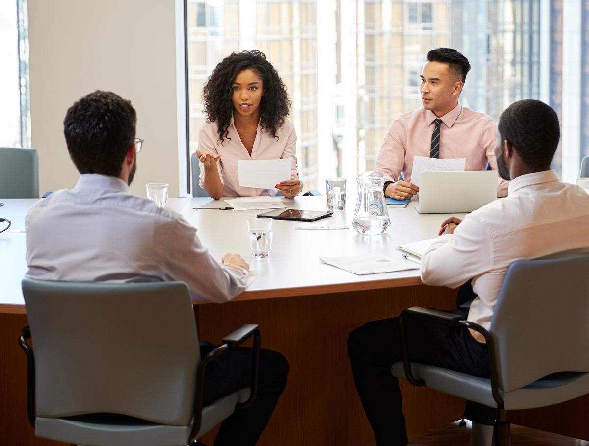 Coworkers around conference table in meeting