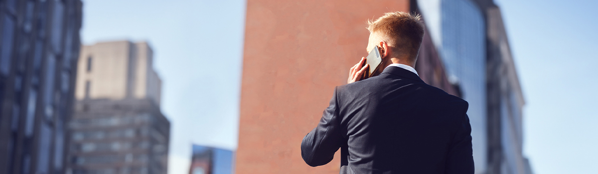 Man with cellphone to ear in city 